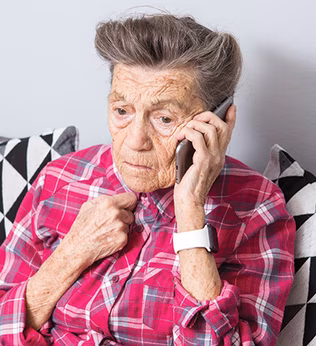 Photo of person on a mobile phone wearing a fuchsia plaid shirt