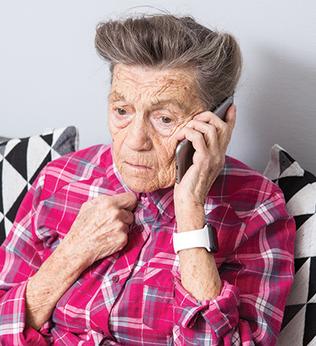 Photo of person on a mobile phone wearing a fuchsia plaid shirt