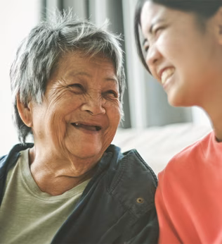Photo of two women laughing together