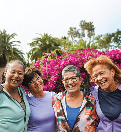 Photo of a group of diverse women laughing outdoors