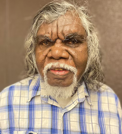 Photo of a man wearing a blue and white plaid shirt