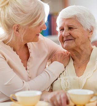 Photo of two women enjoying a tea break together