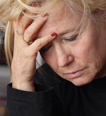 Photo of a woman with her head in her hand