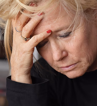 Photo of a woman with her head in her hand
