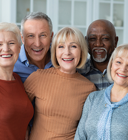 Group of people smiling as they take a selfie