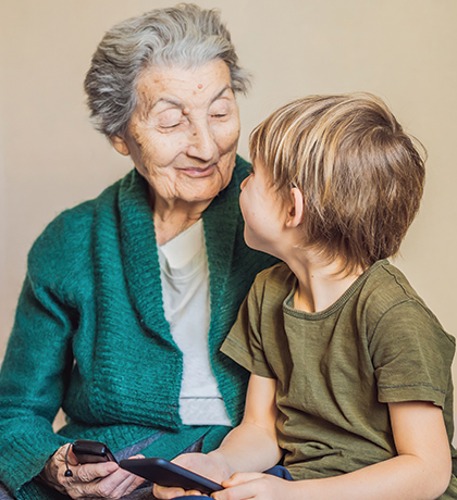 Photo of a senior woman and a young child both wearing green