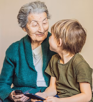 Photo of a senior woman and a young child both wearing green