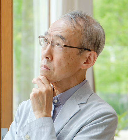 Photo of a man pondering something with his hand on his chin