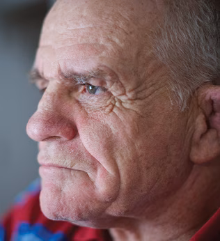 Photo of a man looking intensely towards a light source