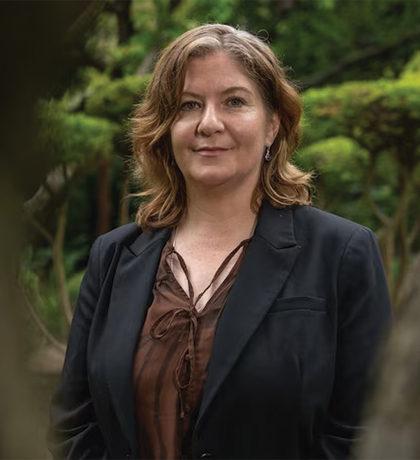 Photo of a woman outdoors wearing a black jacket