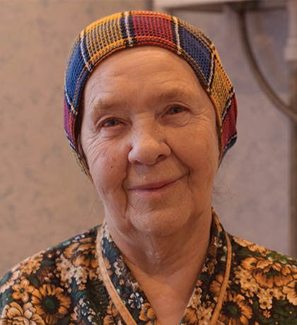 Photo of a woman in floral pyjamas and a knit cap