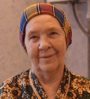 Photo of a woman in floral pyjamas and a knit cap