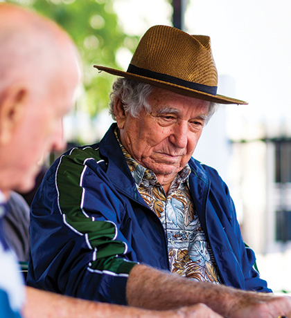 Photo of a man in a straw hat and blue jacket