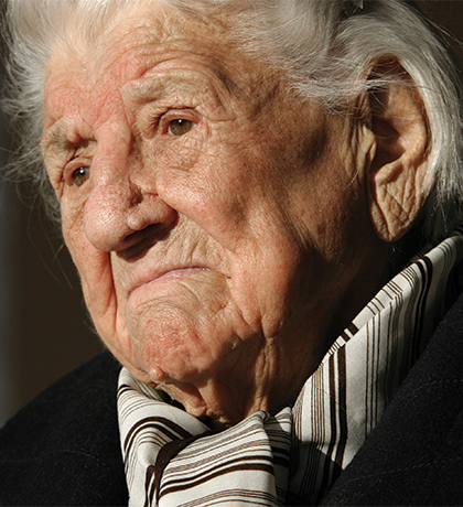 Photo of a person with a striped scarf and black top