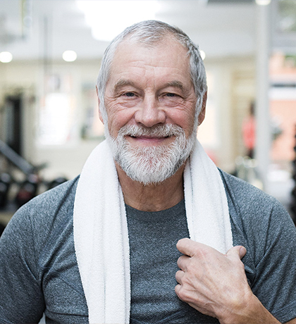 Happy older man at the gym