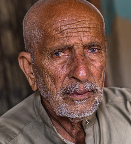 Photo of man with a light beard and light khaki shirt
