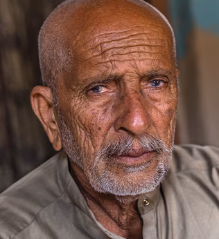 Photo of man with a light beard and light khaki shirt