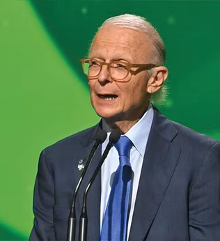 Photo of Dr Brodaty speaking in front of a green screen