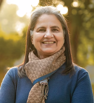 Photo of a woman in a patterned scarf smiling