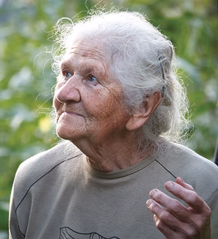 Photo of an elderly lady in a garden
