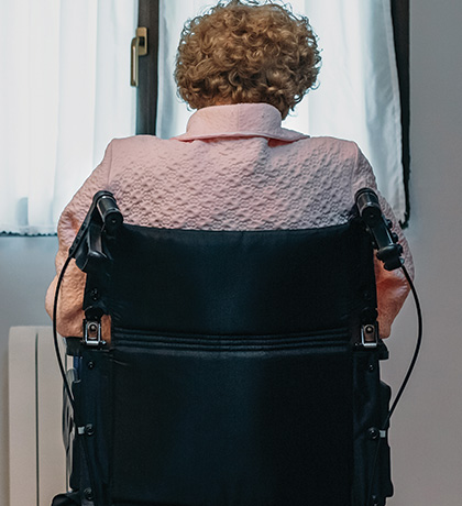 Photo of a woman in a wheelchair with her back to us