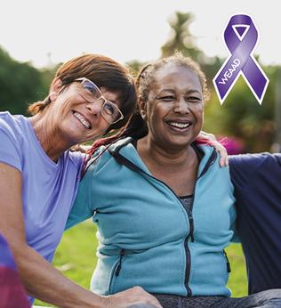 Photo of three friends laughing in a park