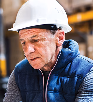 Photo of a man in a hard hat and navy vest