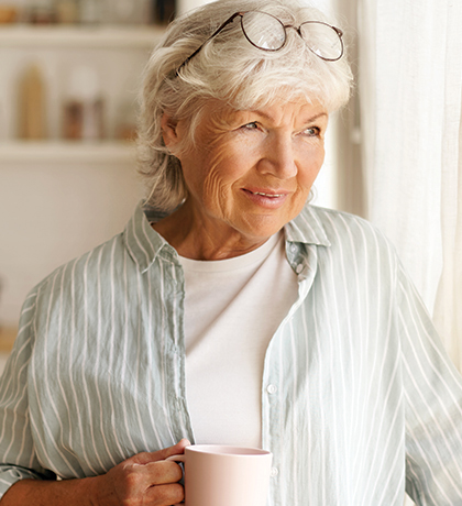 Photo of a woman holding a white coffee mug