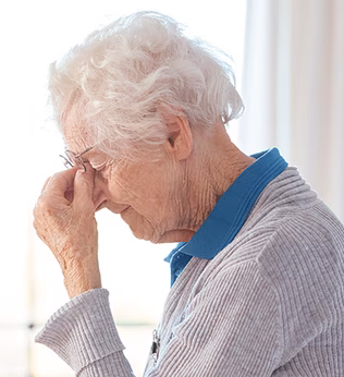 Photo of a woman pinching the bridge of her nose