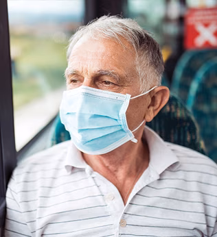 Man on public transport wearing a face mask