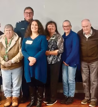 Photo of a group of people smiling at the camera