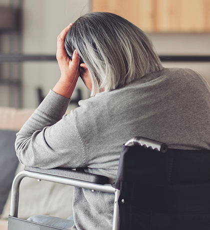 Photo of a person in a wheelchair with her back to us