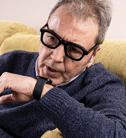 Photo of a man talking into his watch phone