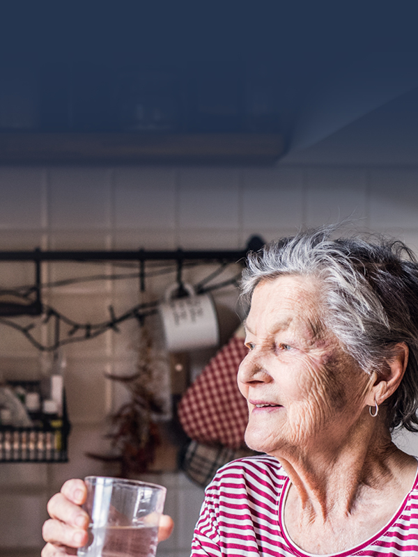 Image of an older woman drinking a glass of water