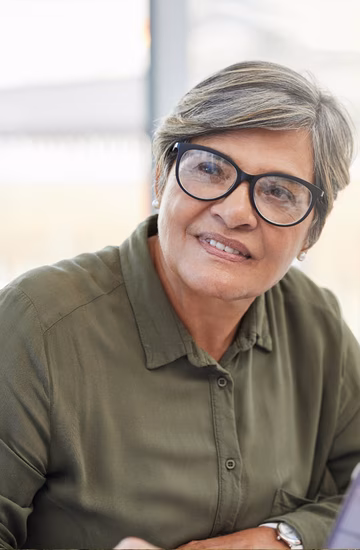 woman with glasses listening to someone else out of frame