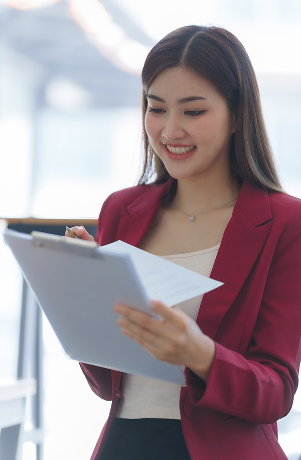 Young woman smiling with clipboard
