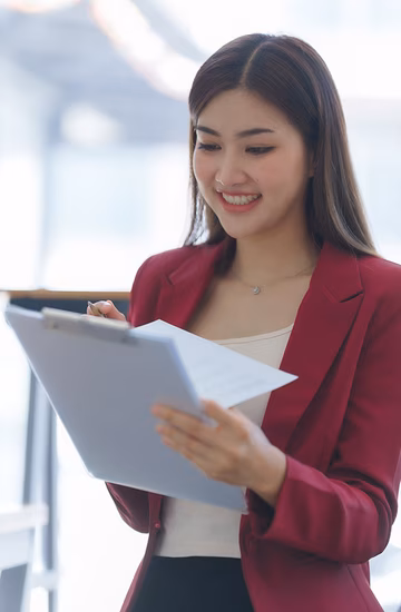 Young woman smiling with clipboard