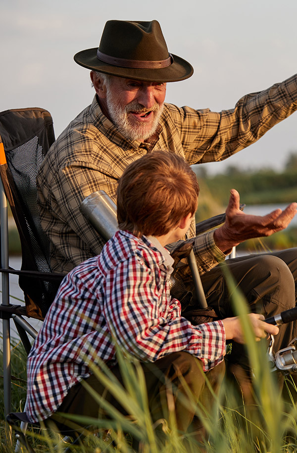 Older man talking with with young boy 