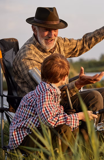 Older man talking with with young boy 