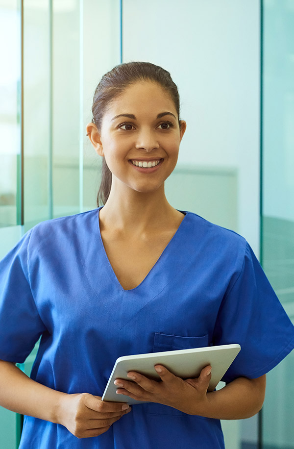 Young female nurse holding tablet device