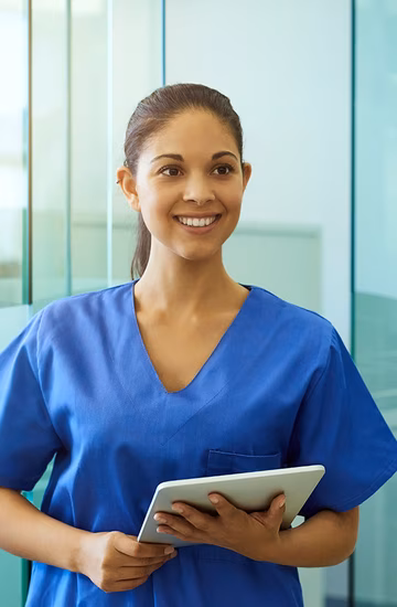 Young female nurse holding tablet device