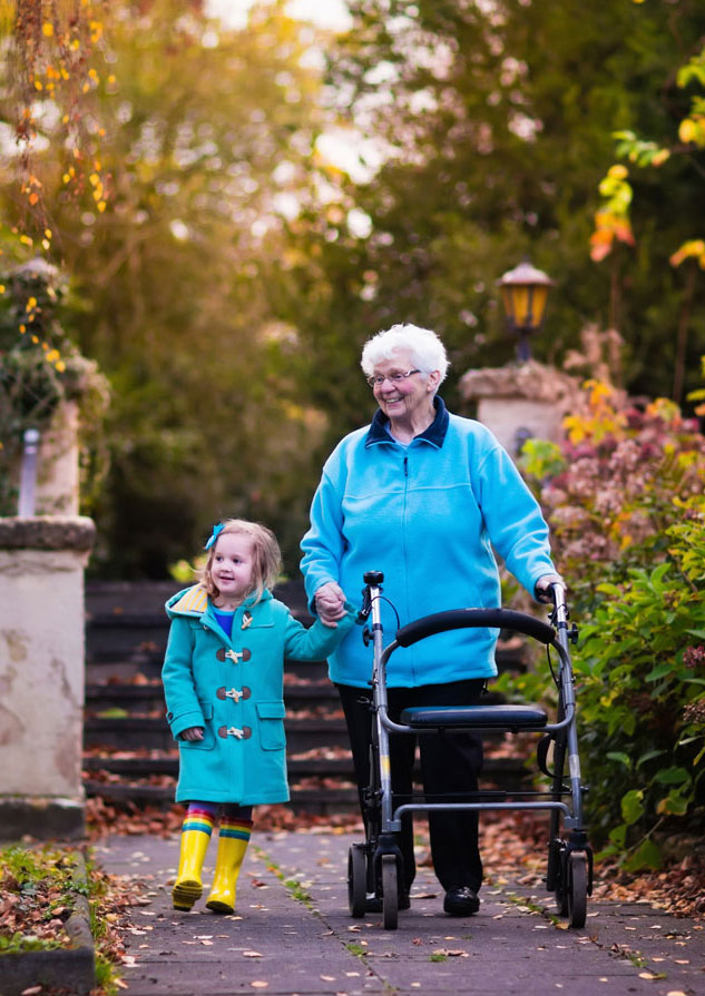Senior woman talking her granddaughter for a walk 