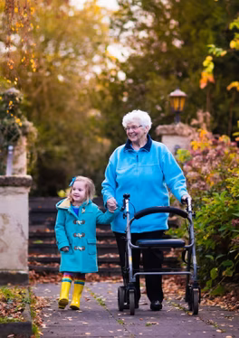 Senior woman talking her granddaughter for a walk 