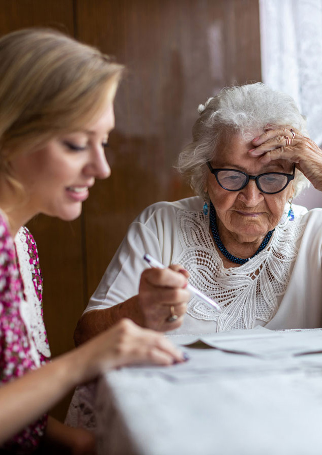 Woman helping elderly woman