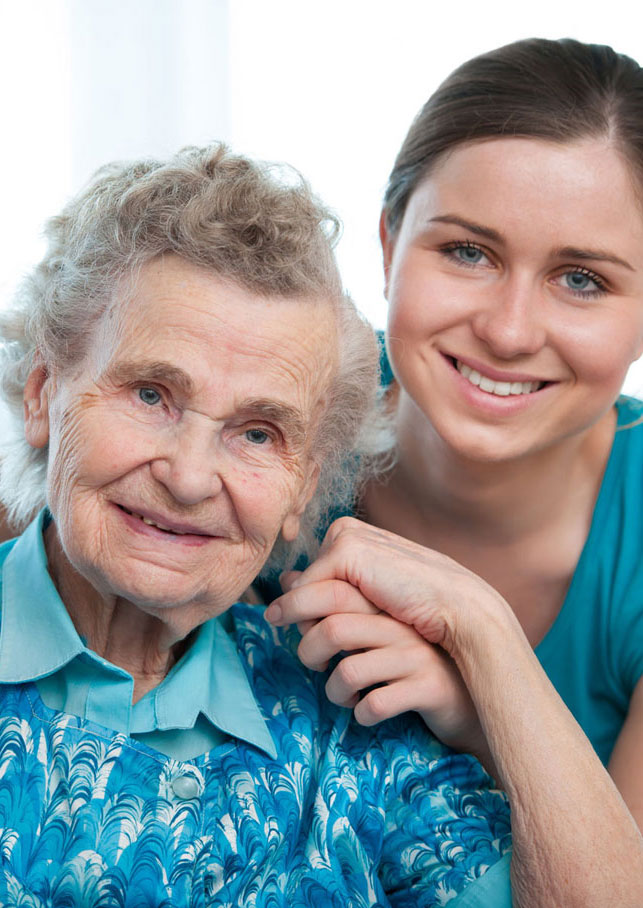 Carer and senior woman in nursing home