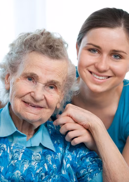 Carer and senior woman in nursing home