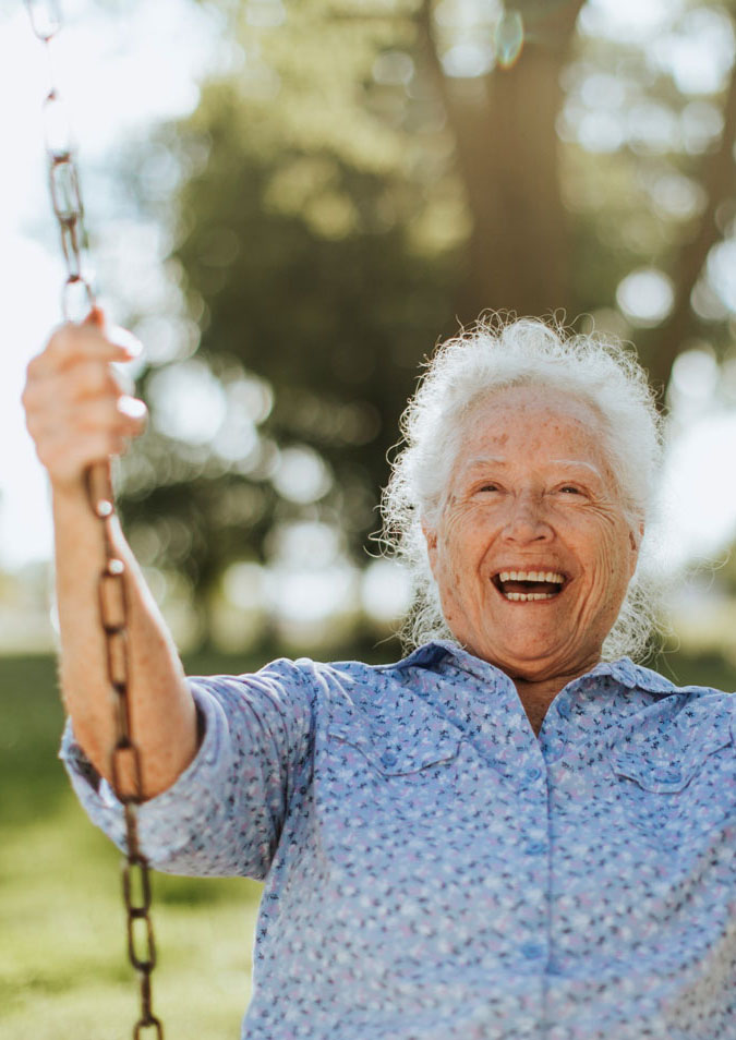 Elderly woman on swing