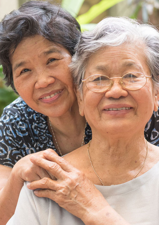 Adult daughter and mother smiling