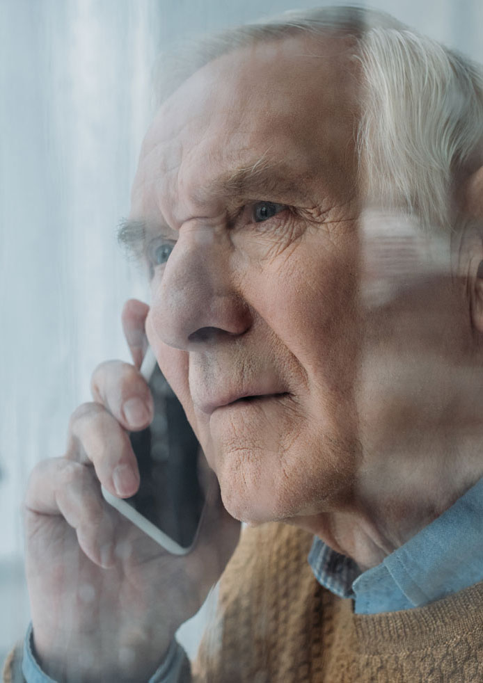 Man on phone behind window
