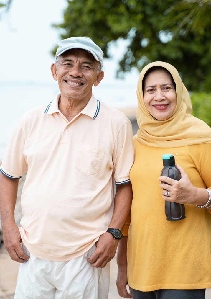 Happy elderly couple on beach